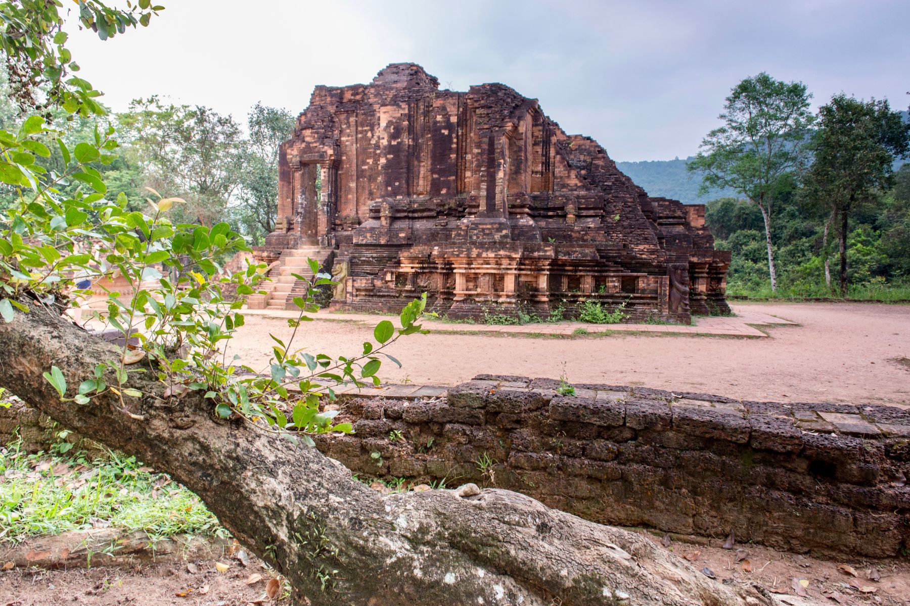 Ancient Hindu temple ruins at My Son Sanctuary surrounded by lush green vegetation in Vietnam