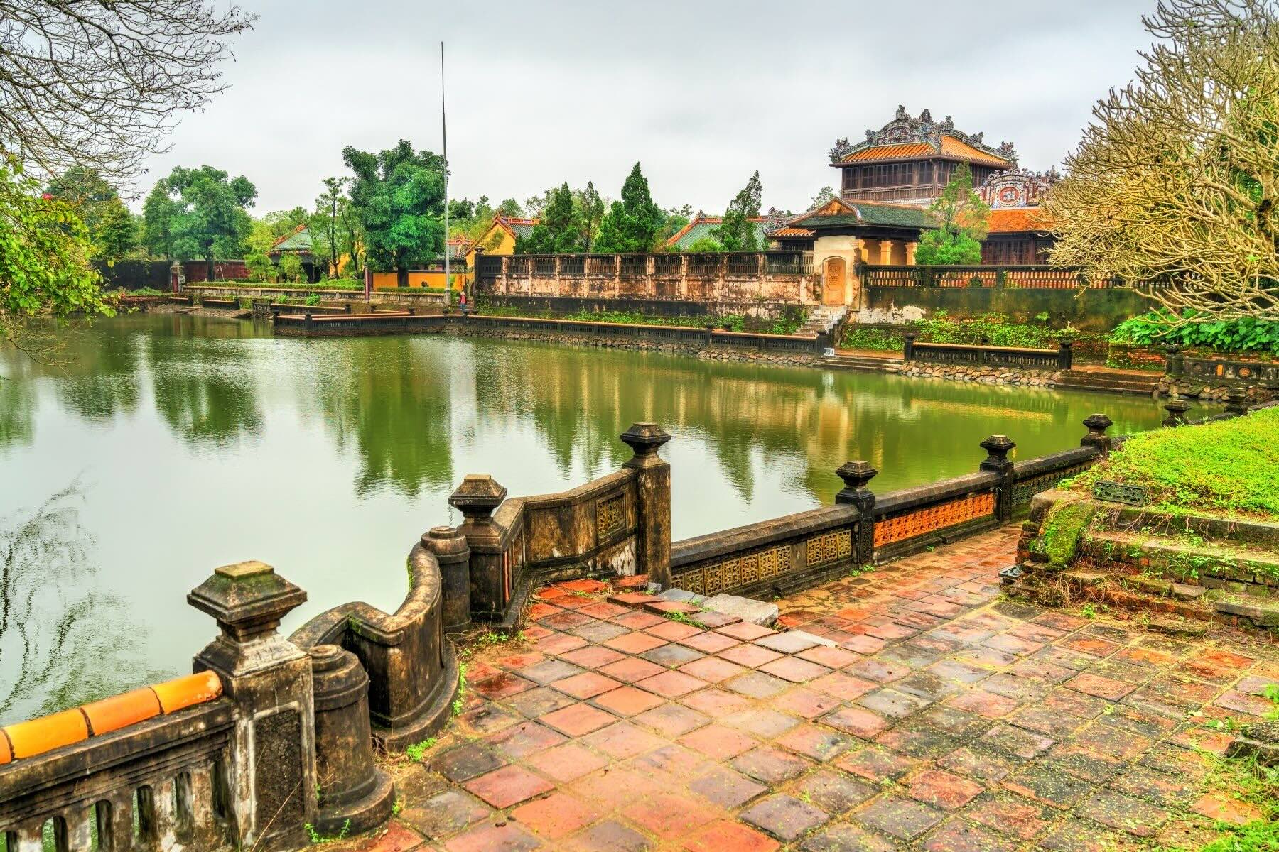 The Imperial City in Hue, Vietnam, featuring majestic gates, traditional architecture, and beautifully landscaped gardens along the Perfume River.