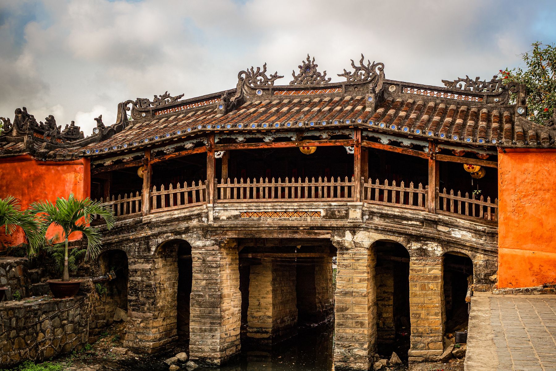 The Japanese Covered Bridge in Hoi An captured in soft morning light, highlighting its intricate architecture and serene surroundings