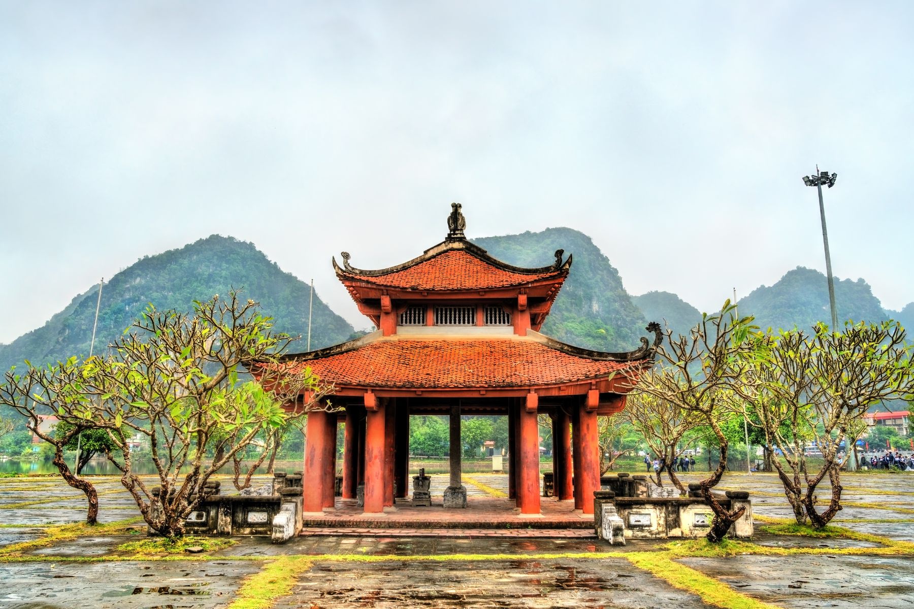 Ly Thai To Beer House at Hoa Lư, showcasing traditional architecture with limestone hills in the background