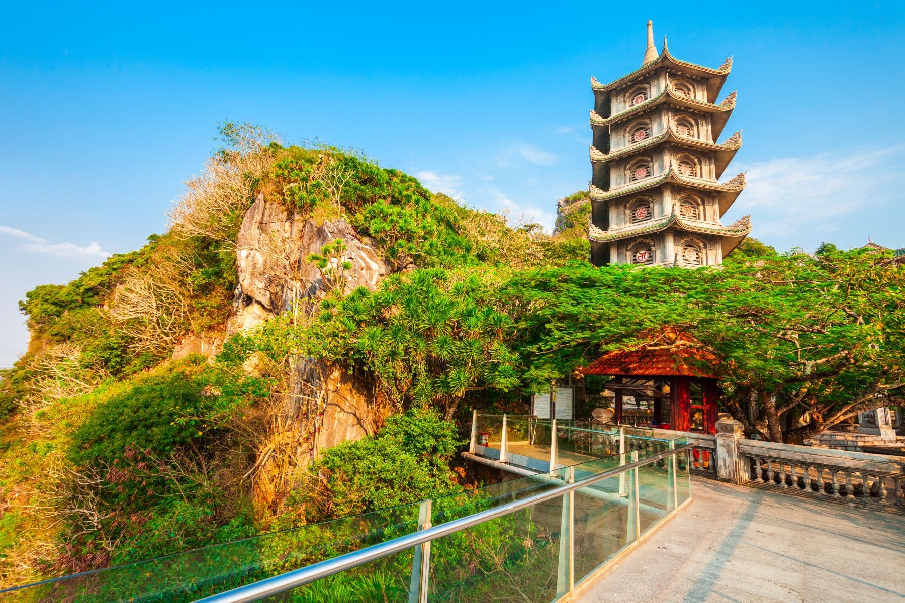 Temple lookout surrounded by lush green jungle and limestone peaks at Marble Mountains, Da Nang, Vietnam