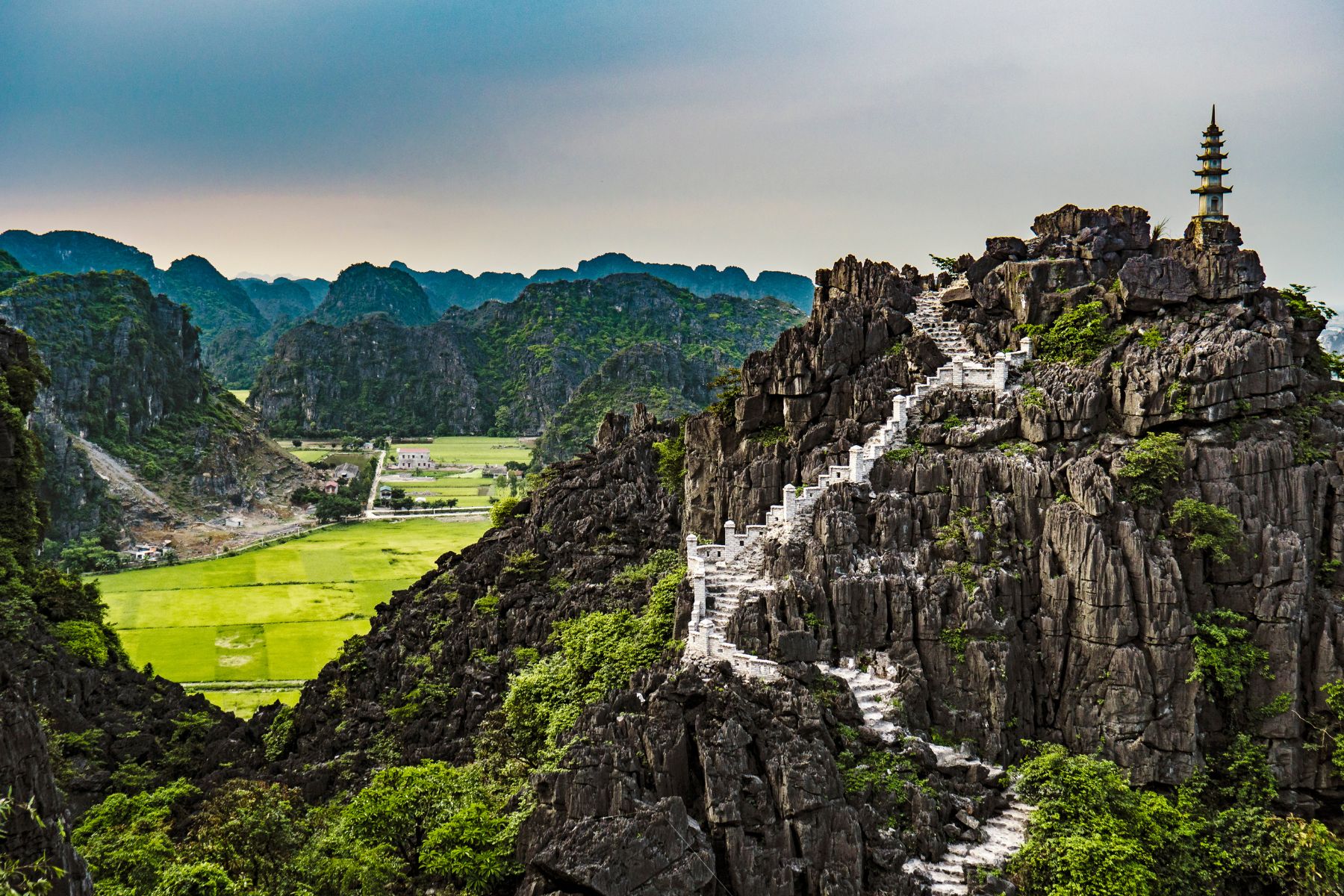 Panoramic view from Múa Mountain in Ninh Bình, overlooking limestone karst mountains and rice paddies