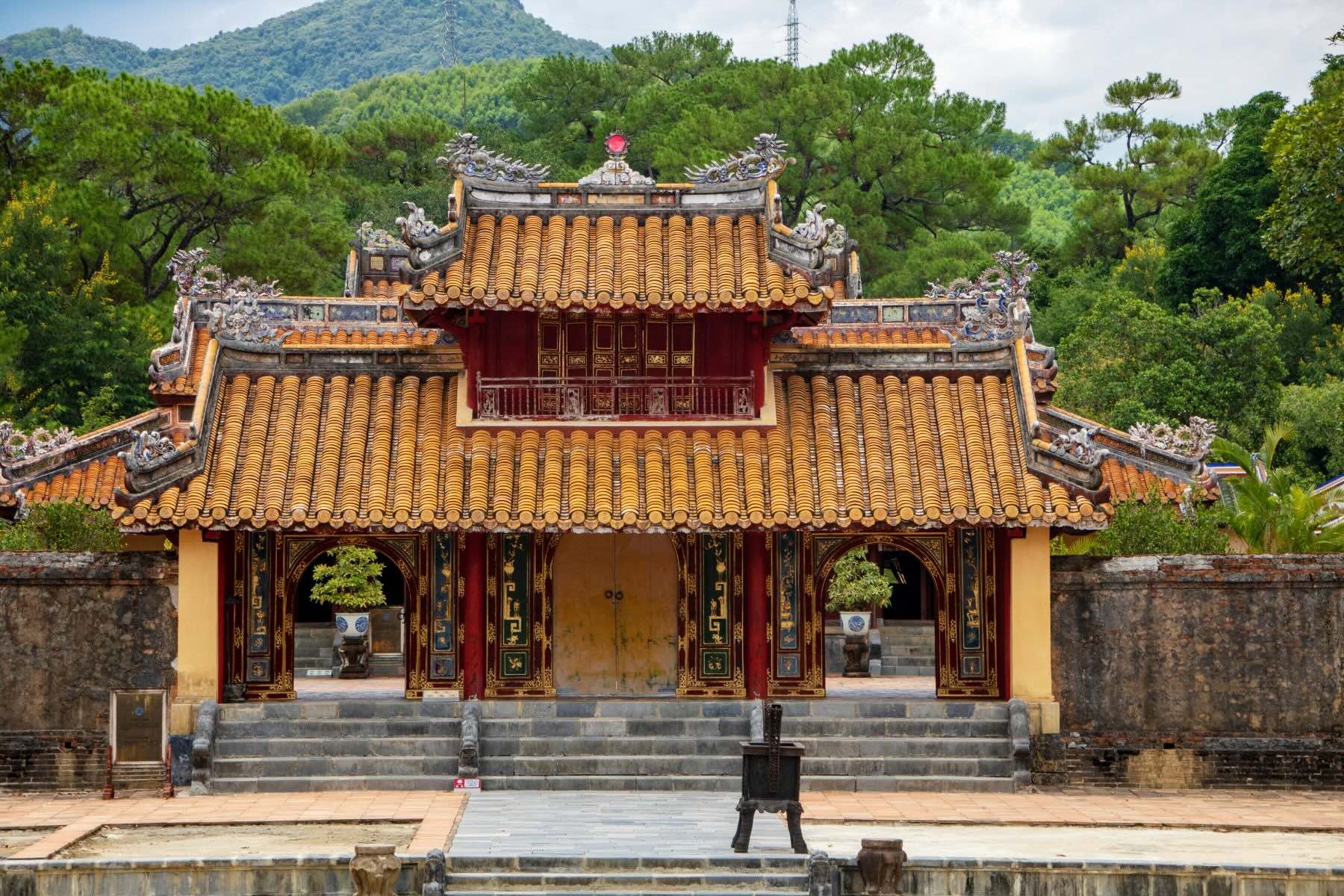 The Tomb of Minh Mang in Hue, Vietnam, showcasing traditional Nguyen Dynasty architecture surrounded by lush gardens and tranquil ponds