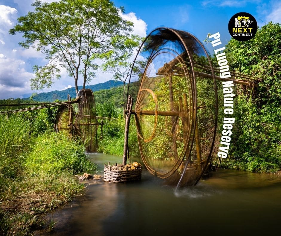 Long exposure image of a waterwheel along a river in Pu Luong Nature Reserve, surrounded by lush jungle scenery