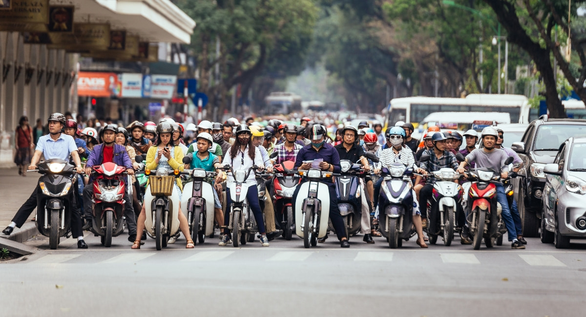 Orderly traffic in Vietnam with motorbike riders wearing helmets and following traffic lights in Ho Chi Minh City, 2025
