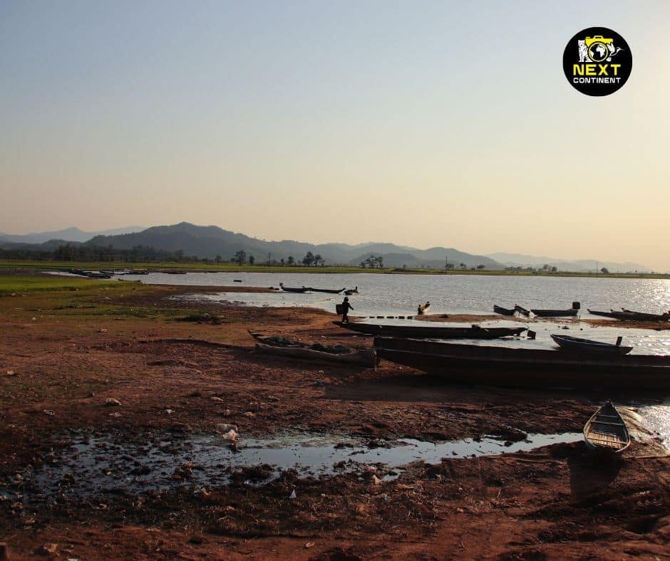 A vast expanse of Lak Lake in Đắk Lắk Province, Vietnam, reflecting the sky on its calm waters.