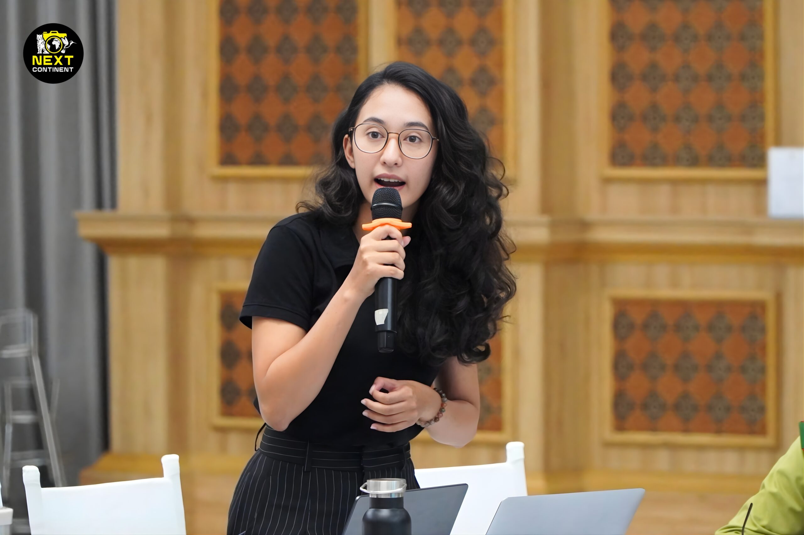 Woman speaking into a microphone during the conservation conference on grey-shanked douc langurs in Vietnam